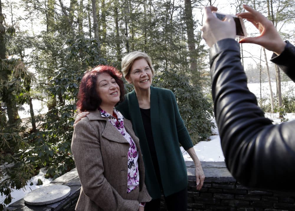 Sen. Elizabeth Warren, D-Mass., right, poses for a photo with a guest at the campaign house party in Salem, N.H. (Elise Amendola/AP)