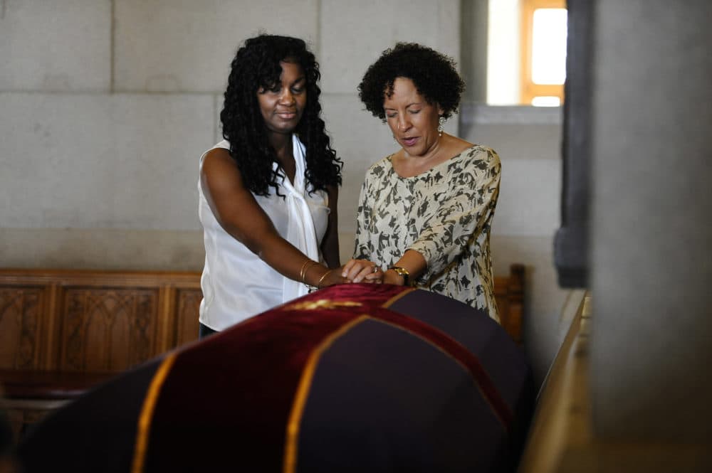 Tamara Lanier of Norwich, Conn., left, and Gabrielle Foreman of Delaware, pray over a casket with the remains of an enslaved man known as Mr. Fortune at the Capitol in Hartford, Conn., Sept. 12, 2013. (Jessica Hill/AP)