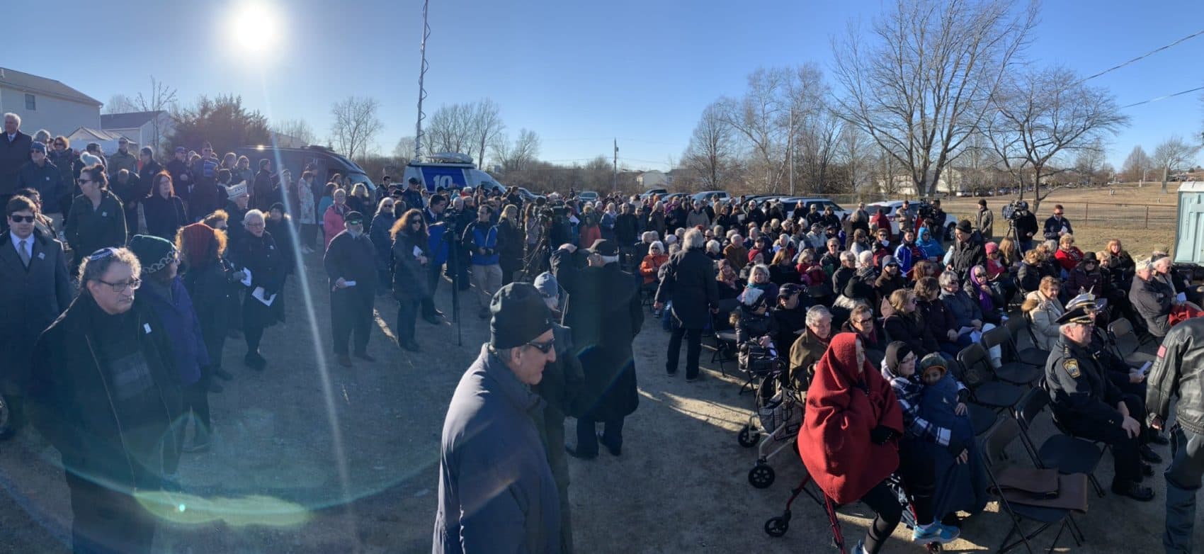 Hundreds gather at a Fall River Jewish cemetery for an antisemitism vigil after dozens of gravestones were vandalized. (Simón Rios/WBUR)