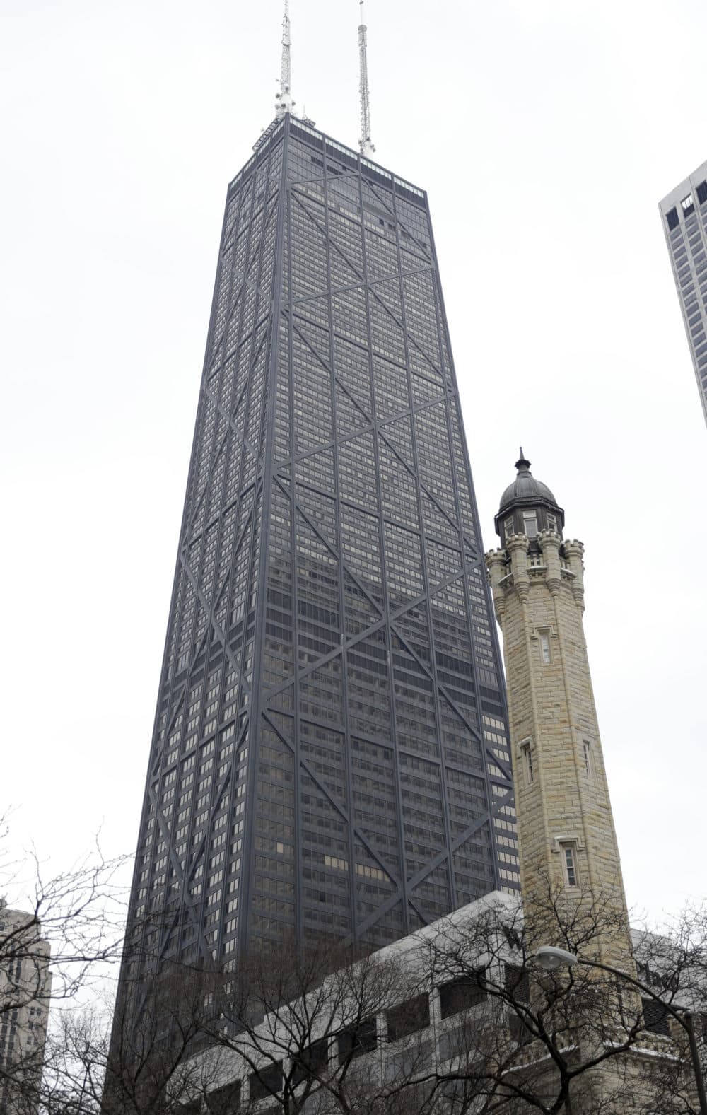 The Hancock Center, Chicago's fourth tallest building, towers over Michigan Ave., and the famous Water Tower, right, Tuesday, Feb. 13, 2018, in Chicago, Ill. (Charles Rex Arbogast/AP)