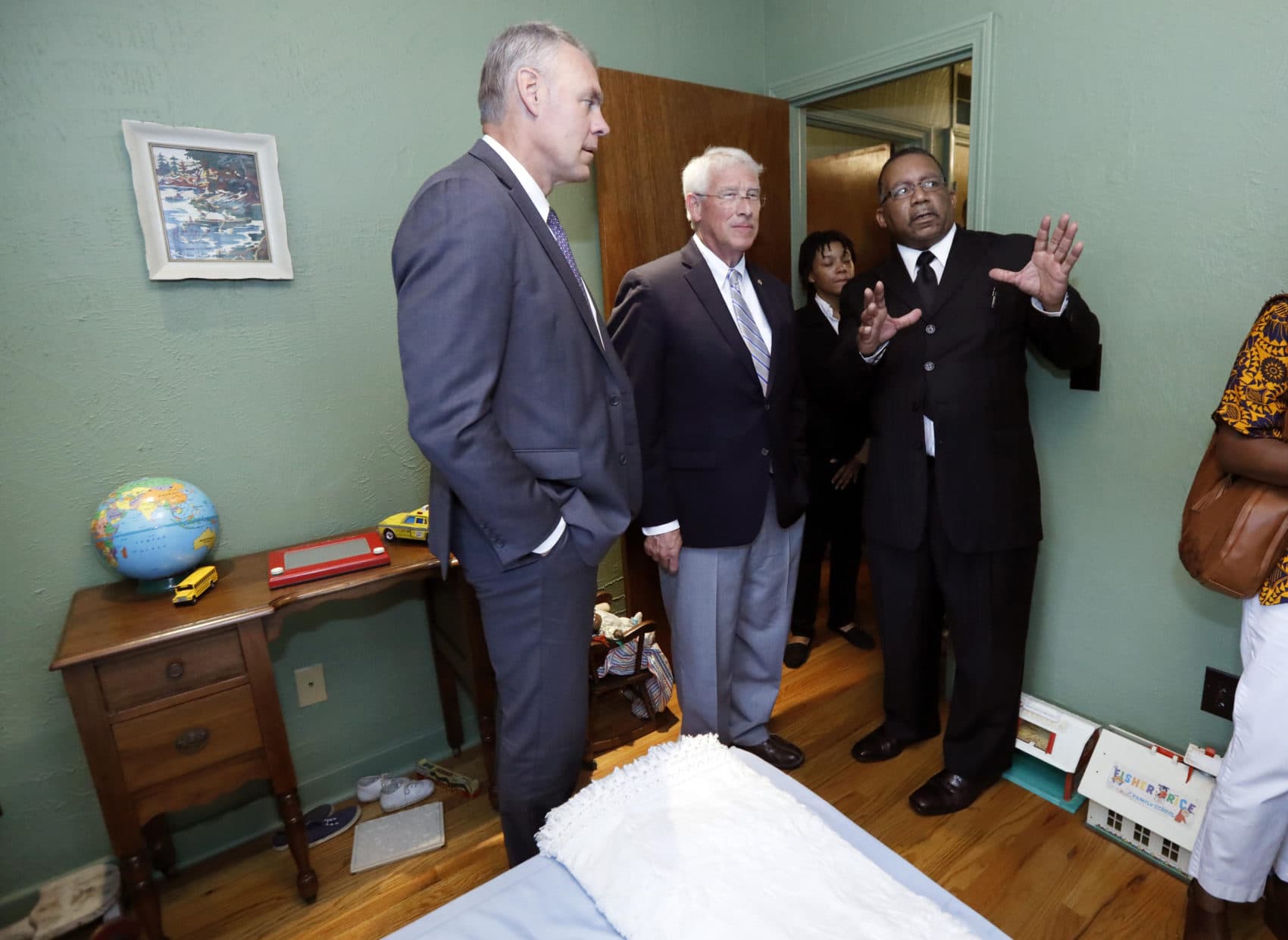 Charles Murchinson of Jackson, right, tells U.S. Sen. Roger Wicker, R-Miss., center and Interior Secretary Ryan Zinke, about the makeup of the neighborhood that the late civil rights activist Medgar and Myrlie Evers lived at in Jackson, Miss., Friday, Aug. 3, 2018. (Rogelio V. Solis/AP)