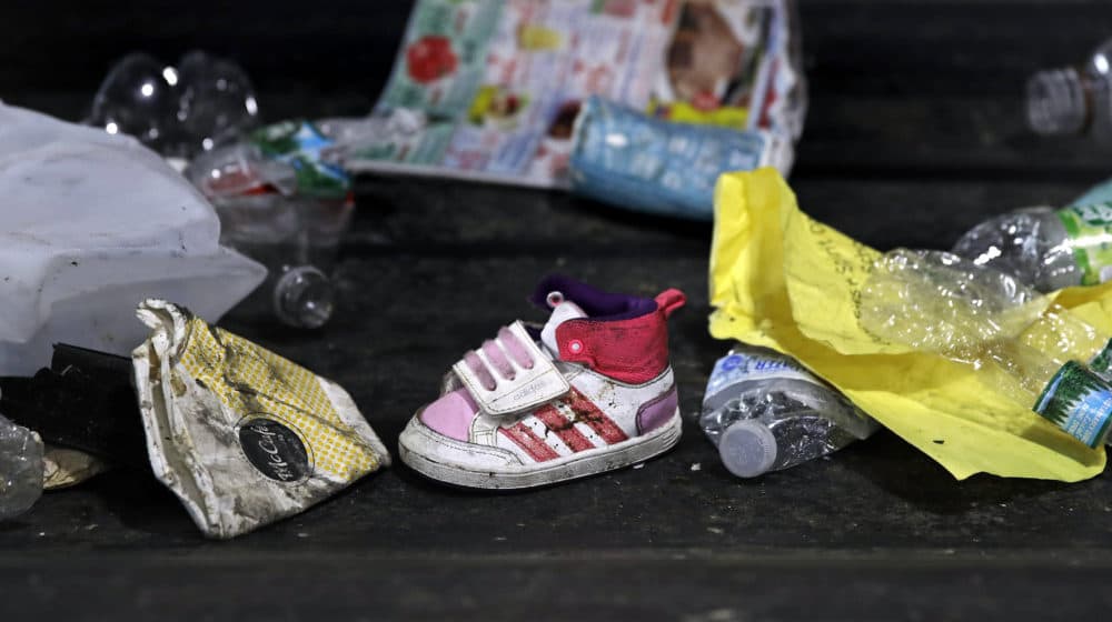 In this 2018 file photo, a child's shoe is co-mingled with recyclable materials at EL Harvey &amp; Sons, a waste and recycling company, in Westborough. (Charles Krupa/AP)