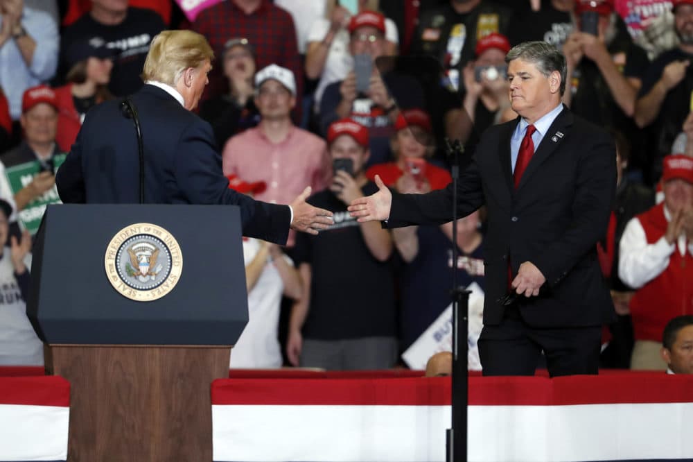 President Donald Trump shakes hands with Fox News Channel's Sean Hannity, right, during a campaign rally Monday, Nov. 5, 2018, in Cape Girardeau, Mo. (Jeff Roberson/AP)