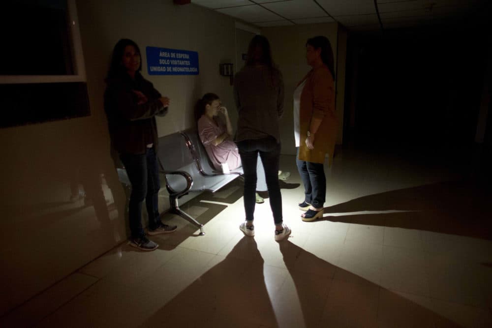 Mothers and relatives wait outside of an intense care room for babies at a clinic, during a power outage in Caracas, Venezuela, Thursday, March 7, 2019. (Ariana Cubillos/AP)