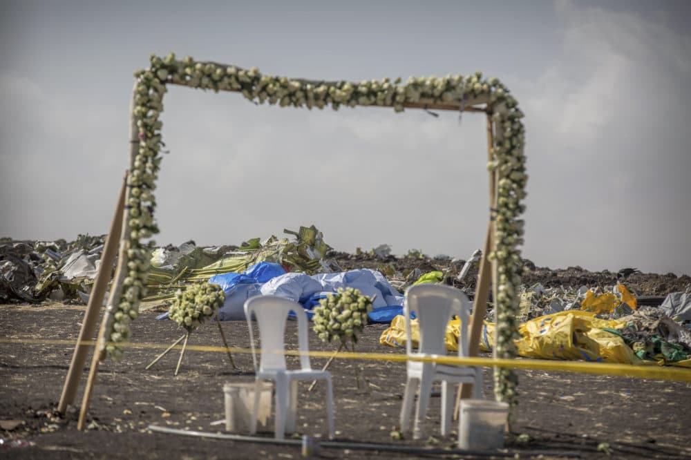 Wreaths and floral installations stand next to piles of wreckage at the scene where the Ethiopian Airlines Boeing 737 Max 8 crashed shortly after takeoff on Sunday killing all 157 on board. (Mulugeta Ayene/AP)