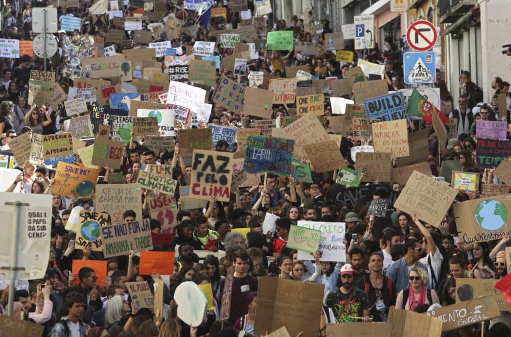 Thousands of high school students in Lisbon, Portugal, carry posters and chant slogans during a protest march through Lisbon while taking part in a global school strike for climate change (Armando Franca/AP)