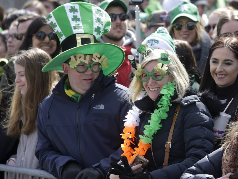 Spectators wear Irish-themed hats and glasses during the parade. (Steven Senne/AP)