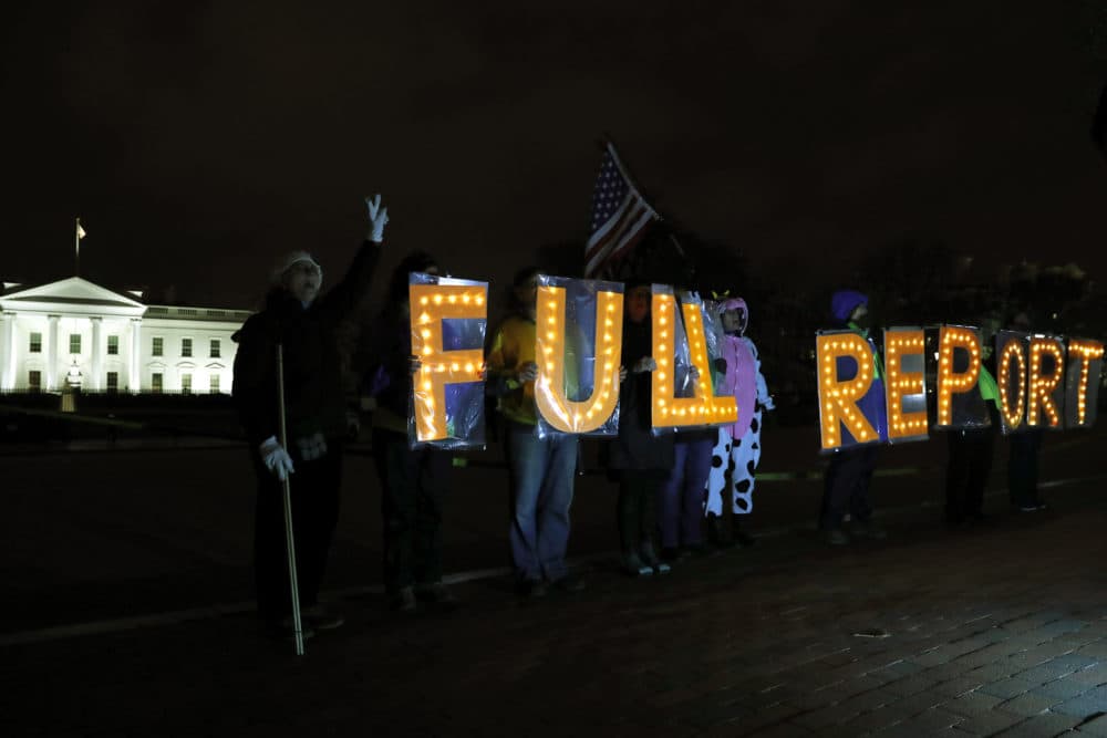 Members of the protest group Herndon Reston Indivisible and Kremlin Annex hold signs saying "Full Report," on Monday, March 25, 2019. (Jacquelyn Martin/AP)