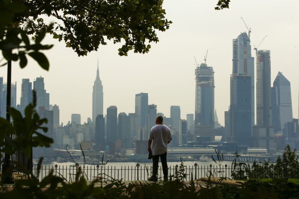 A man takes a look at the haze over the New York skyline during a heat advisory on August 17, 2018, in Weehawken, New Jersey. (Eduardo Munoz Alvarez/Getty Images)