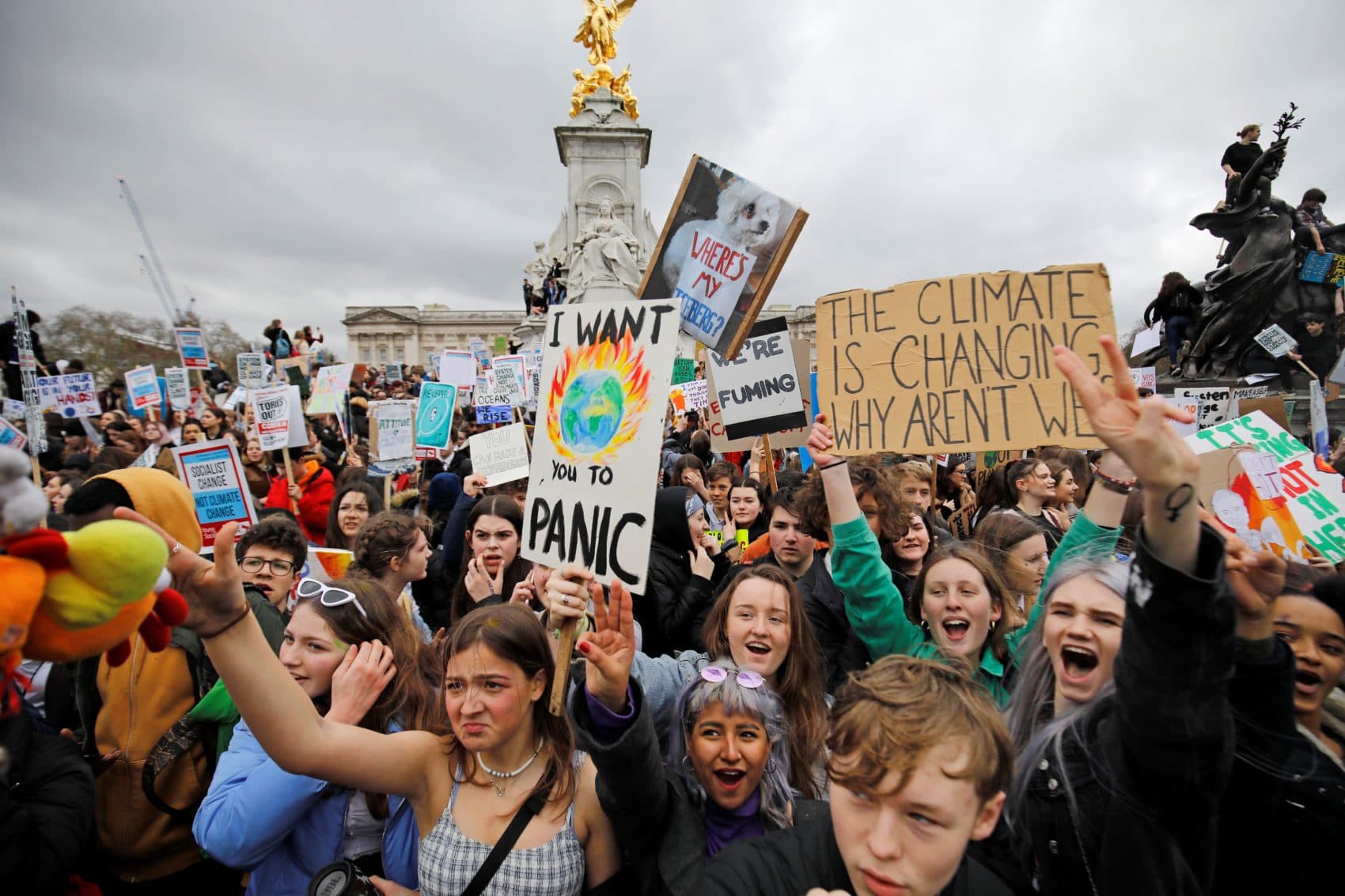 Young demonstrators in the U.K. hold placards as they protest around the Queen Victoria Memorial during the "Global Strike 4 Climate" protest march, outside of Buckingham Palace in central London on March 15, 2019. (Tolga Akmen/AFP/Getty Images)