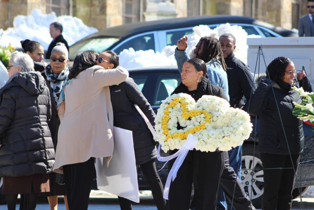 Mourners gather outside the funeral of Jassy Correia. (Quincy Walters/WBUR)