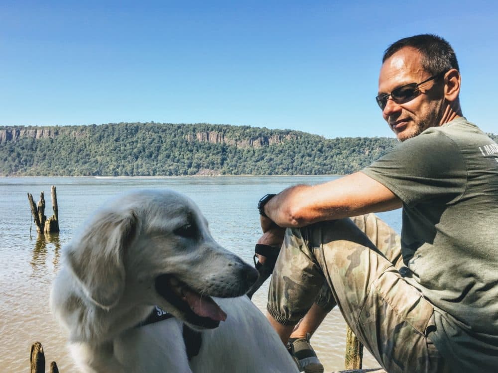 Timofey Yuriev and his golden retriever. (Melissa Kho, Timofey Yuriev/CVJTF Group).