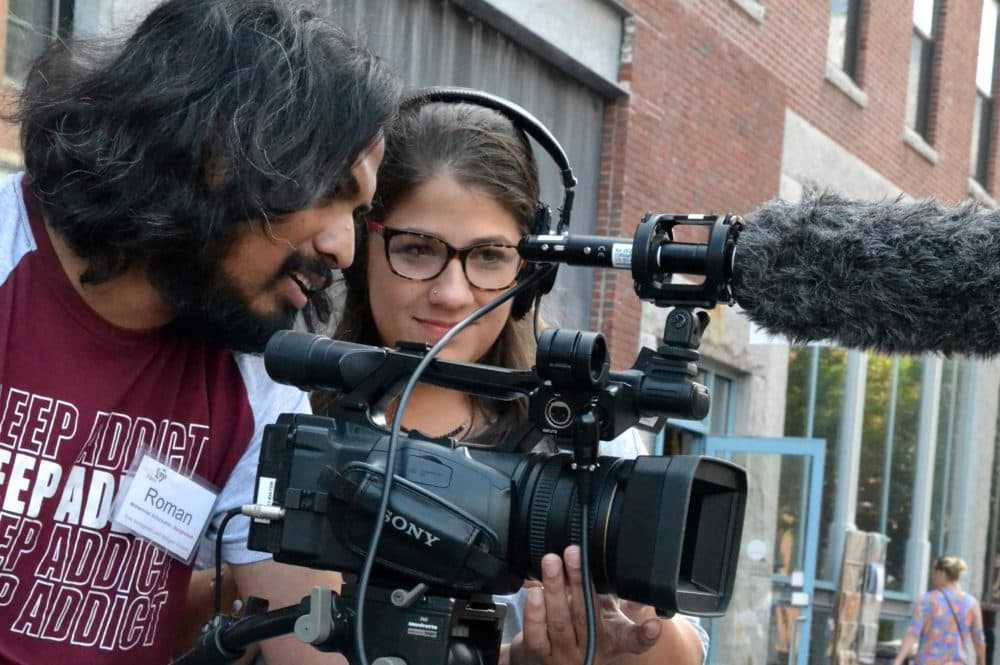 Filmmakers Mohammad (Roman) Arifuzzuman, left, and Katsyris (Katsy) Rivera Kientz work on a field production exercise at the SOWA Market in August 2017. (Courtesy Christine Arveil)