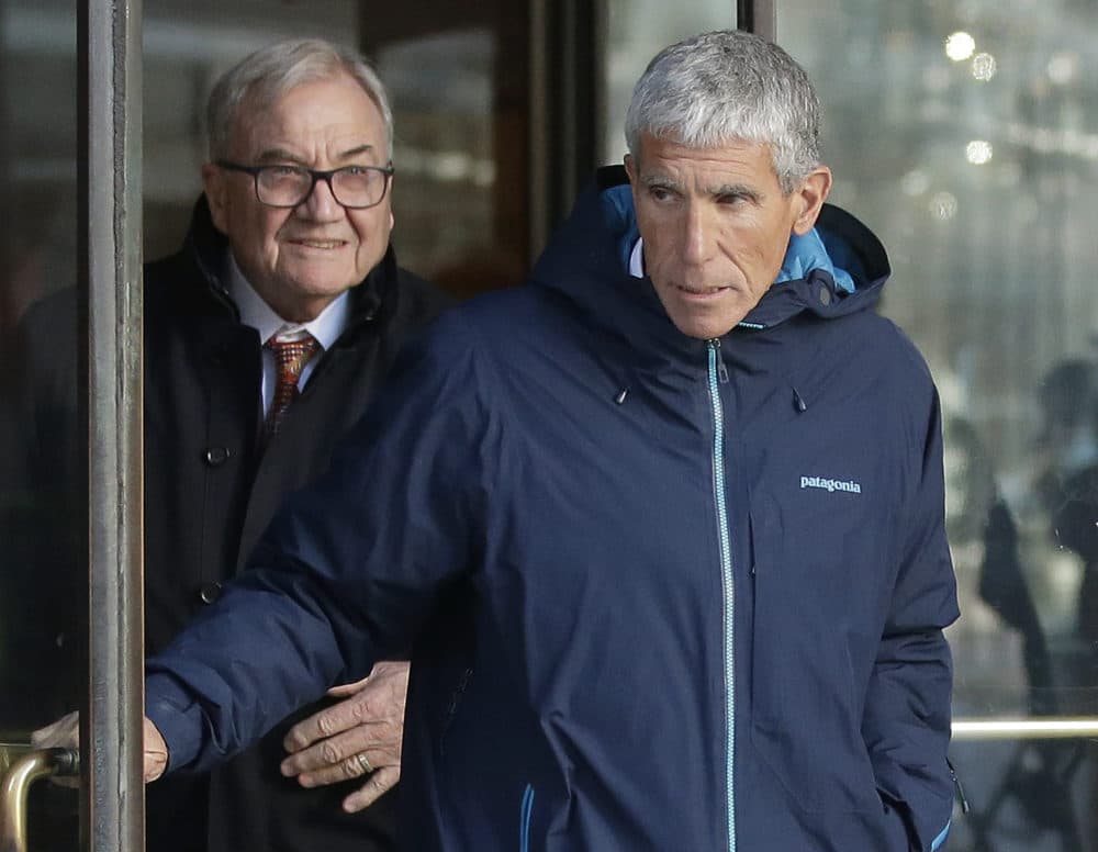 William &quot;Rick&quot; Singer, front, founder of the Edge College & Career Network, exits federal court in Boston on Tuesday, March 12, 2019, after he pleaded guilty to charges in a nationwide college admissions bribery scandal. (Steven Senne/AP)