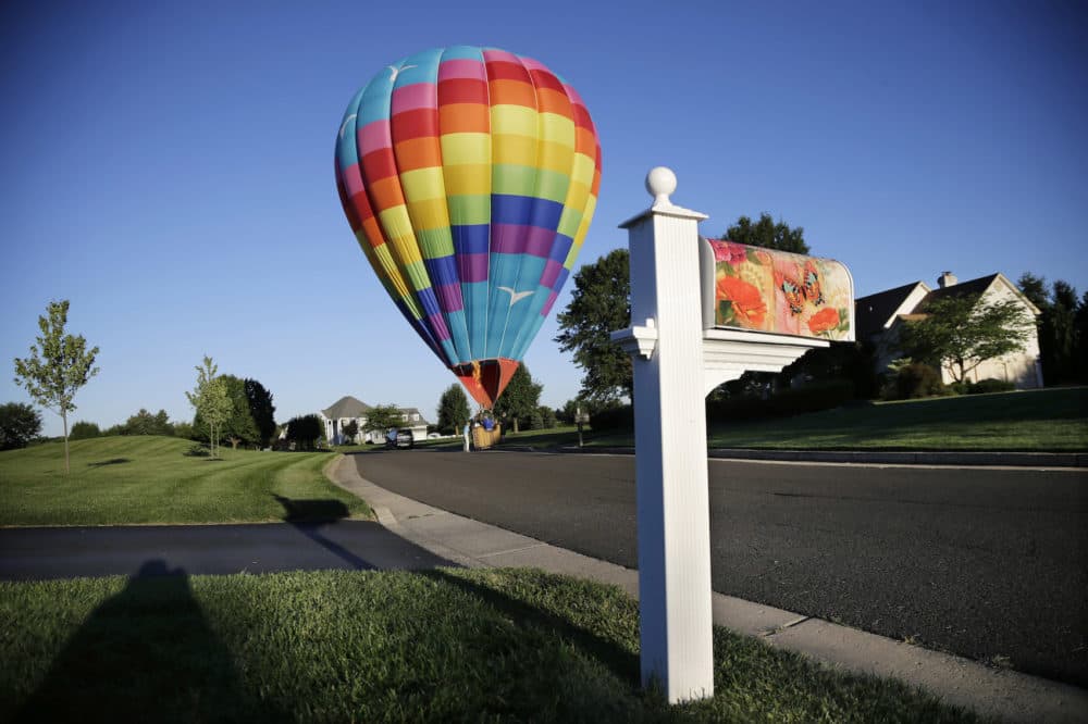 A large hot air balloon lands in the road near Newtown, Pa., Friday, Sept. 6, 2013. (Mel Evans/AP)