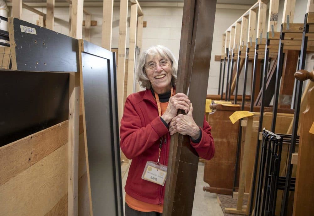 Barbara Smith, one of the founders of Household Goods in Acton, Mass. moving bed frames. (Robin Lubbock/WBUR)