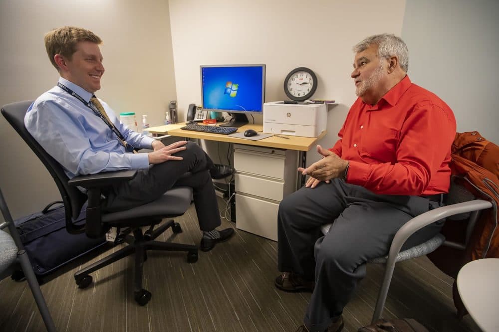 A patient speaks with Dr. David Kroll about some of the issues he is experiencing during his visit at the urgent care facility at the Brigham and Women's Psychiatric Specialties Clinic. (Jesse Costa/WBUR)