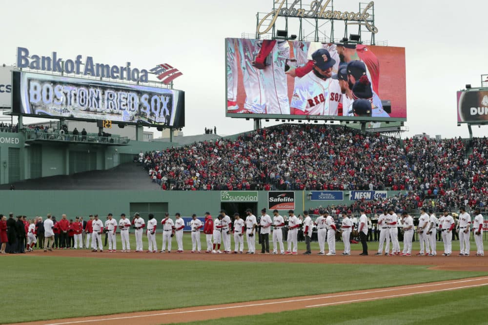 Boston Red Sox's Mookie Betts is displayed on the video sign as he joins teammates in a ceremony to receive their World Series rings before the home opener baseball game. (Charles Krupa/AP)