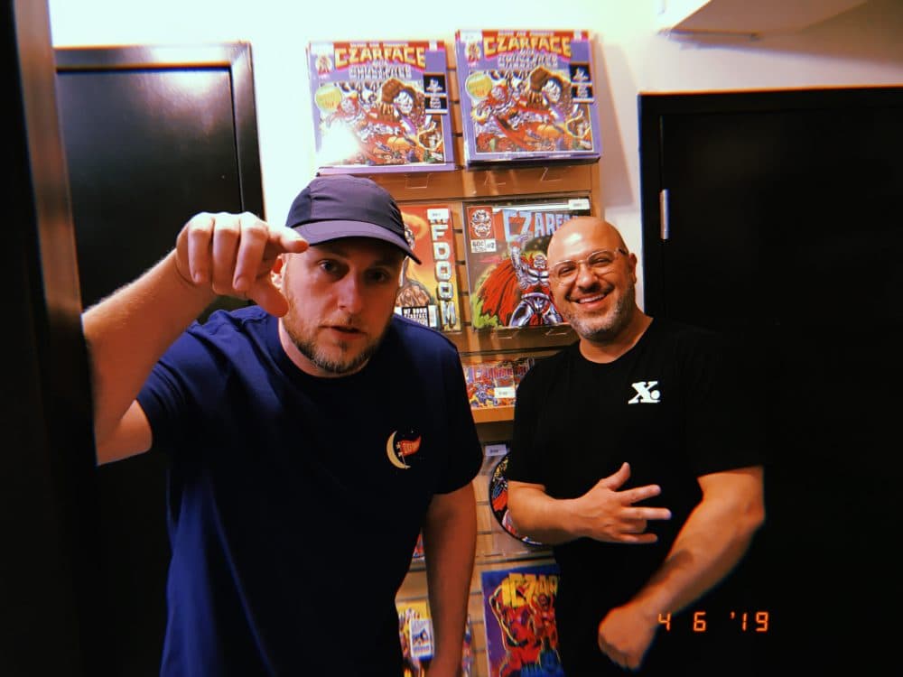 MC Esoteric and DJ 7L stand in front of Czarface records at Newbury Comics in Boston. (Brendan McGuirk for WBUR)