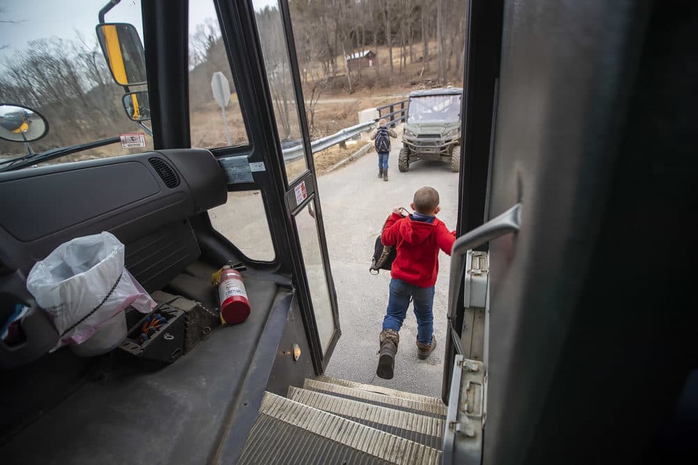 Two Colrain Central School students are dropped off to an awaiting parent with an all terrain vehicle to take them home. (Jesse Costa/WBUR)