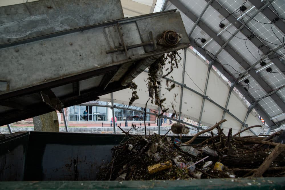 Garbage moves along a conveyor belt into Mr. Trash Wheel's &quot;tum tum&quot; — a dumpster. (Rosem Morton for Here &amp; Now)