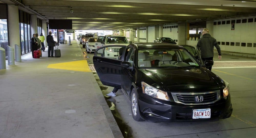 An Uber driver drops off passengers at Logan’s Terminal B. (Robin Lubbock/WBUR)