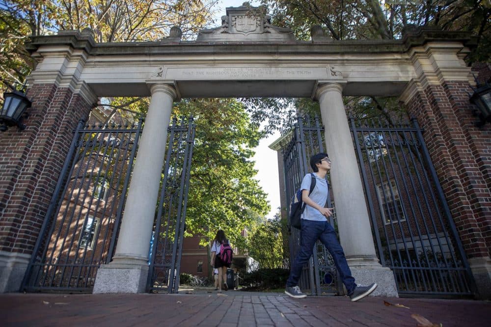 Harvard students walk through the Class of 1875 Gate in Harvard Yard. (Jesse Costa/WBUR)