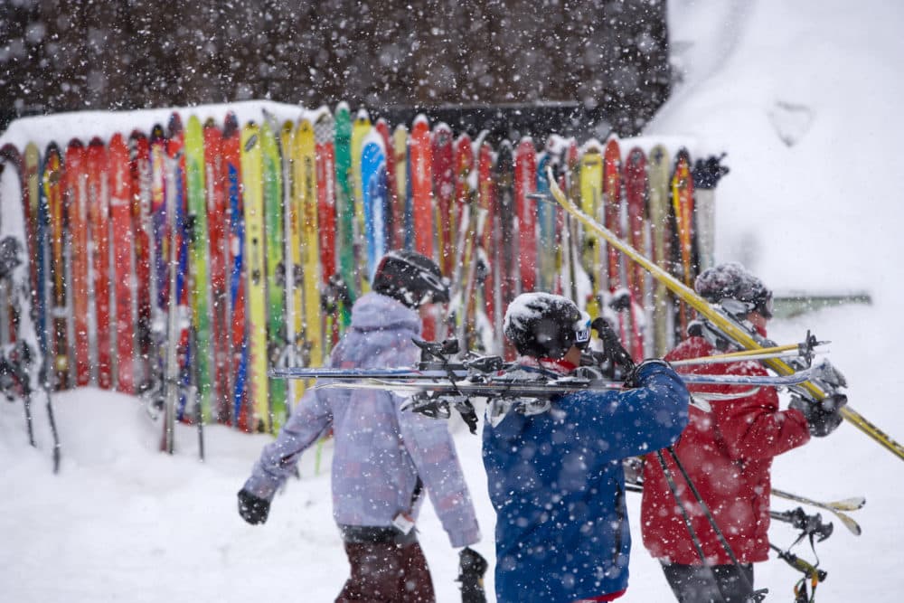 Skiers walk bye a ski fence after a day of skiing at Crested Butte, Colo. on Friday, Feb. 19, 2010. (Nathan Bilow/AP)
