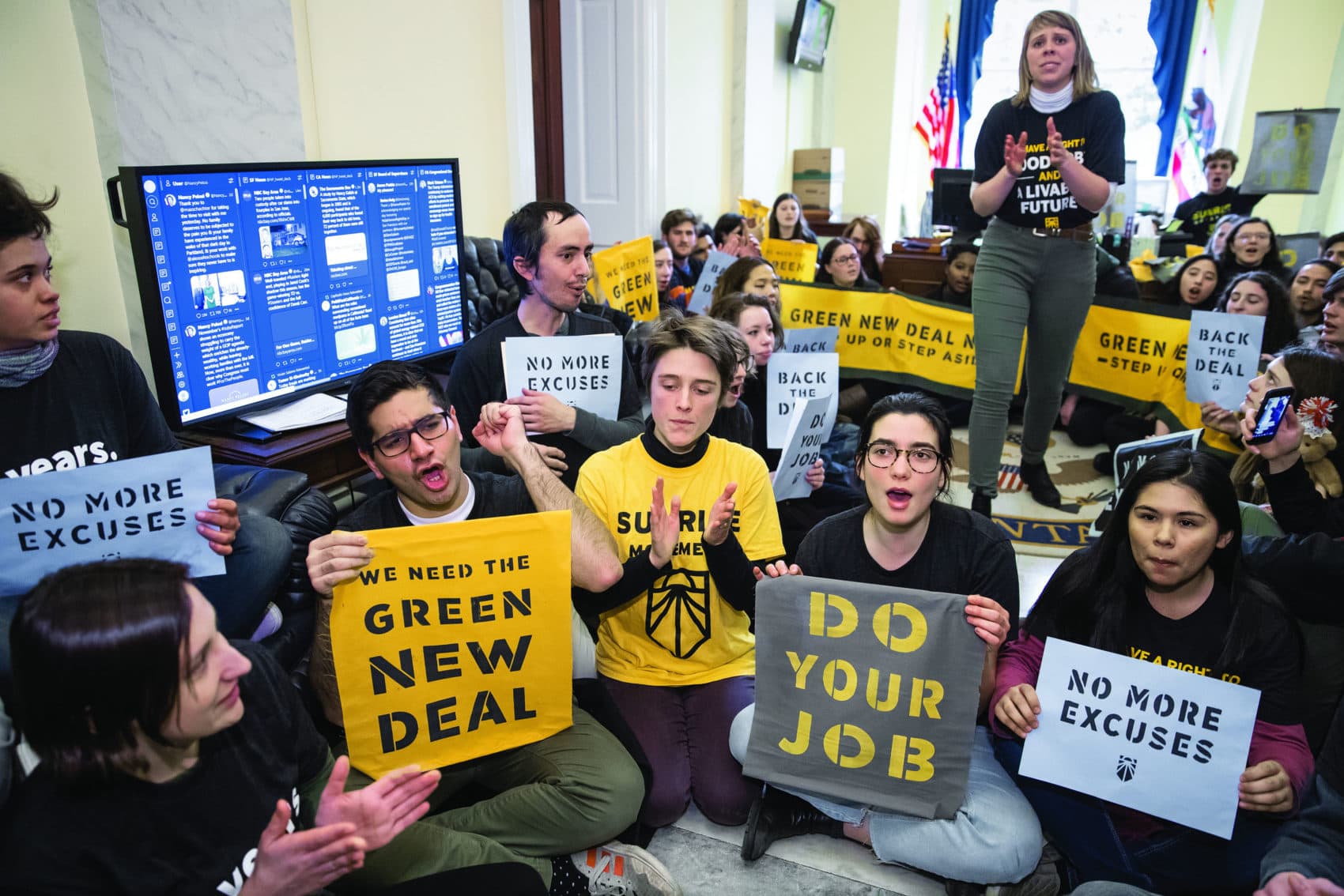 Sunrise Movement activists occupy the office of House Democratic Leader Nancy Pelosi as they try to pressure Democratic support for a sweeping agenda to fight climate change, on Capitol Hill in Washington, Monday, Dec. 10, 2018. (AP Photo/J. Scott Applewhite)