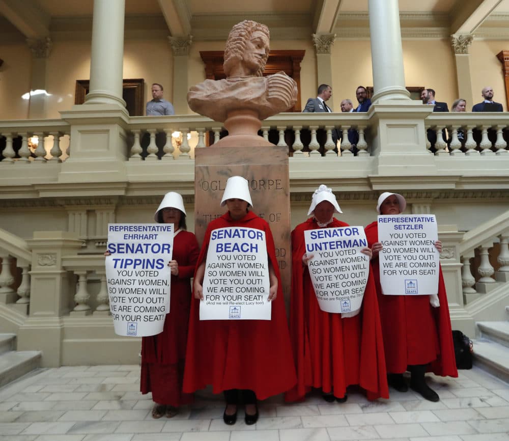 Women hold signs to protest HB 481 at the state Capitol in Atlanta on , Tuesday, April 2, 2019. (John Bazemore/AP)