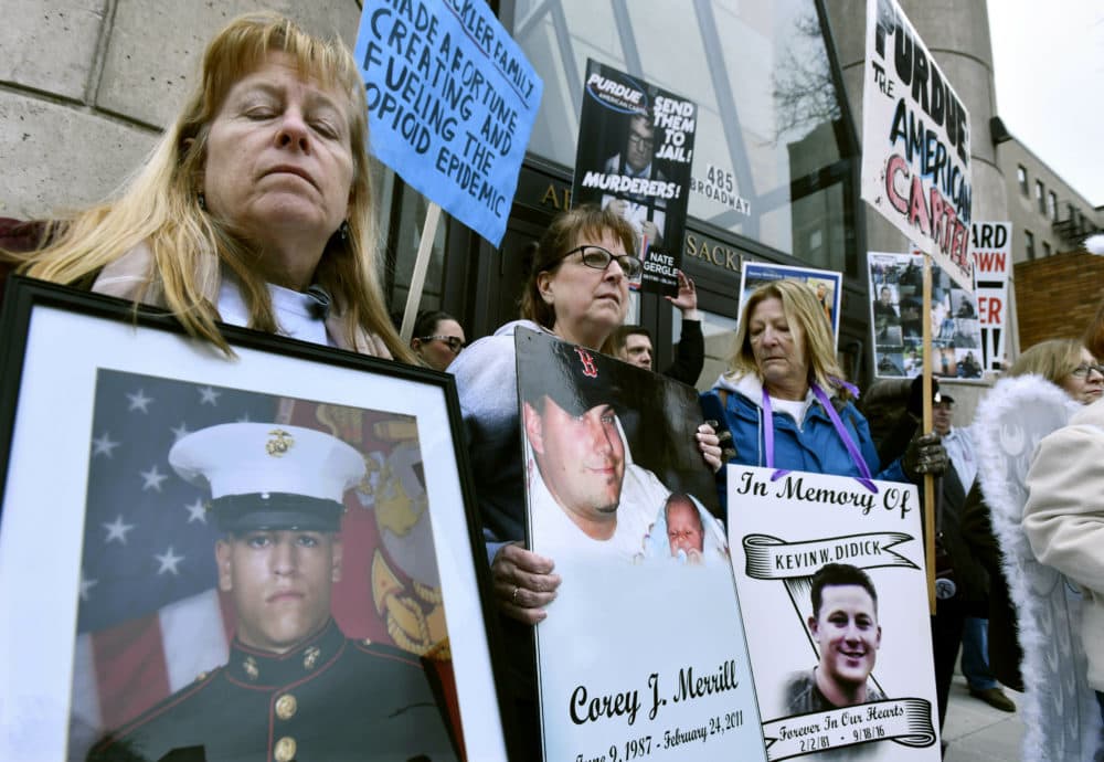 People including Cheryl Juaire, second from left, of Marlborough, Mass., protest in front of the Arthur M. Sackler Museum at Harvard University on April 12. (Josh Reynolds/AP)