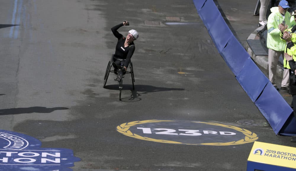 Manuela Schar, of Switzerland, celebrates as she heads to the finish line to win the women's handcycle division. (Charles Krupa/AP)