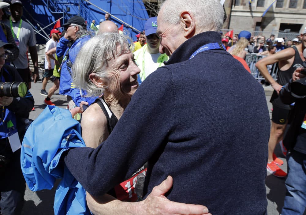 Joan Benoit Samuelson, the first women's Olympics marathon winner, is embraced after finishing the Boston Marathon on Monday -- the 40th anniversary of her first Boston victory. (Winslow Townson/AP)