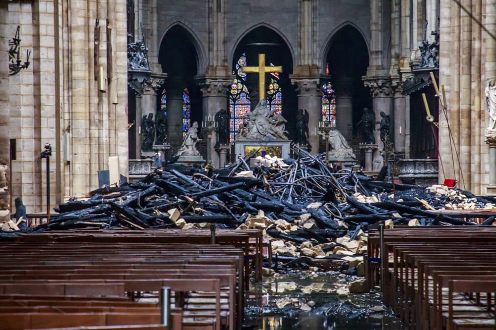 After a 12-hour battle, the flames at Notre Dame Cathedral were extinguished. Here, the debris is seen on Tuesday. (Christophe Petit Tesson, Pool via AP)