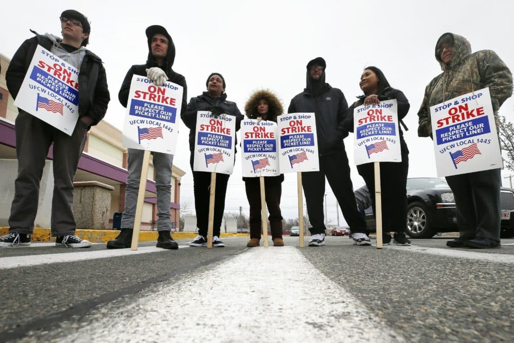 Striking workers stand on a picket line outside the Stop & Shop supermarket in Revere on Thursday. A tentative deal ending the strike was reached on Sunday. (Michael Dwyer/AP)