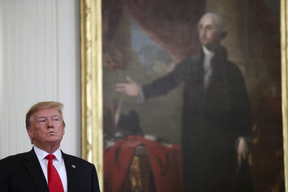 President Donald Trump stands near a portrait of George Washington at an event in the East Room of the White House on Thursday, April 18, 2019. (Andrew Harnik/AP)
