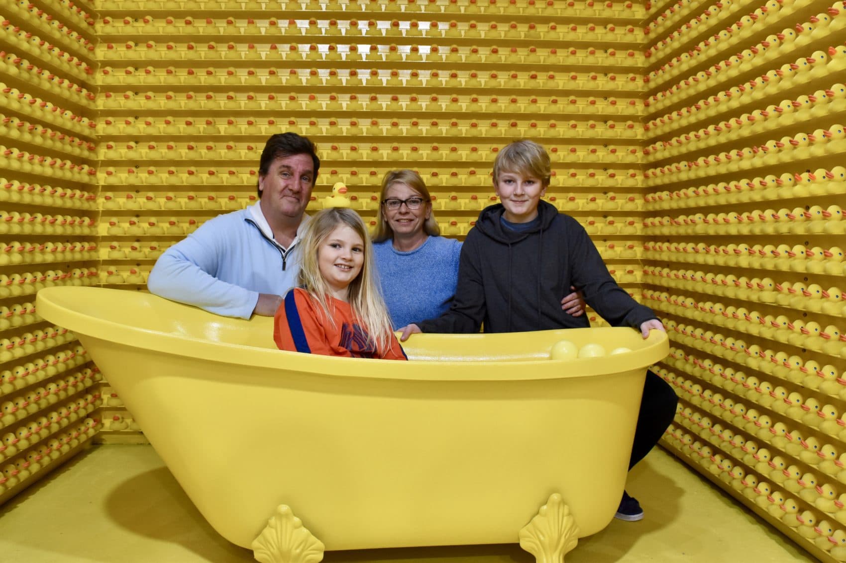 The O'Connor family poses in the bathtub room. From left, Bill, Anne, Kelly and Bill. (Meghan B. Kelly/WBUR)