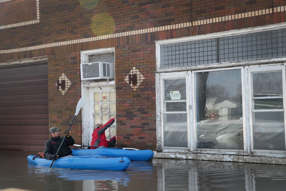 Residents try to enter their business by kayak on March 20, 2019 in Hamburg, Iowa. (Scott Olson/Getty Images)
