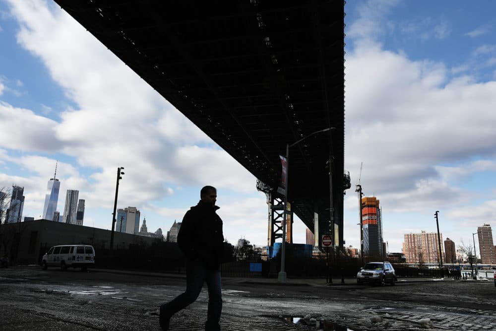A man walks under the Manhattan Bridge on February 16, 2017 in New York City. (Spencer Platt/Getty Images)