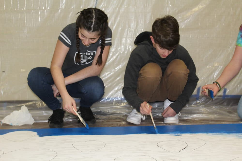 Students at Pine Ridge forget the Camp Fire and put their paint brushes to work. (Ashley Bailey/Here &amp; Now)