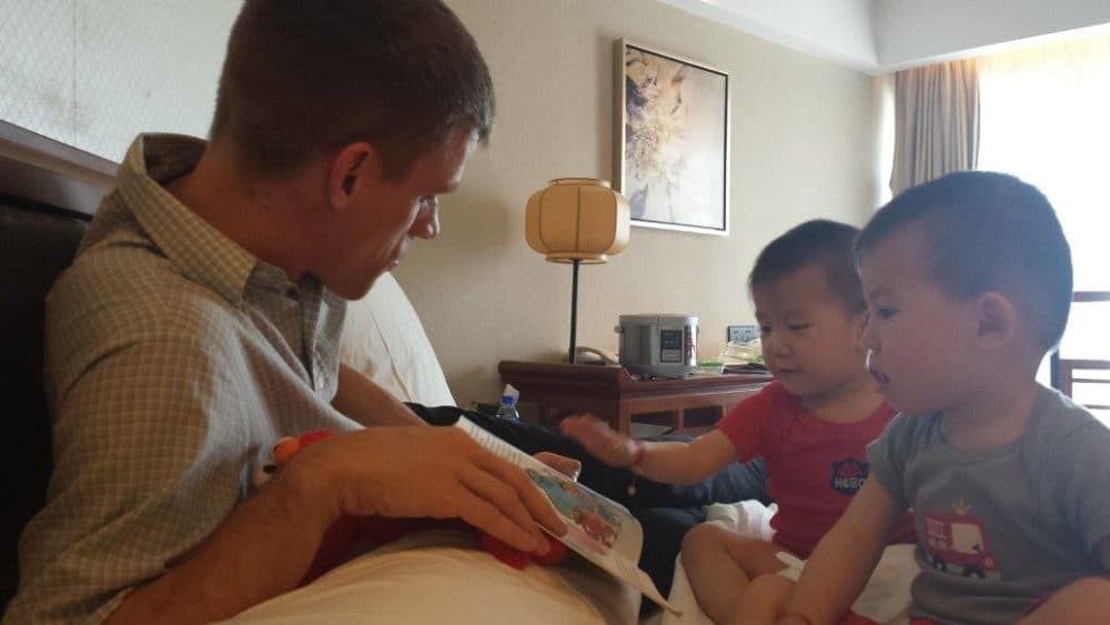 Matt Smith reads to his sons, Luke and Andrew, after adopting them in China. (Courtesy of Kristi Smith)