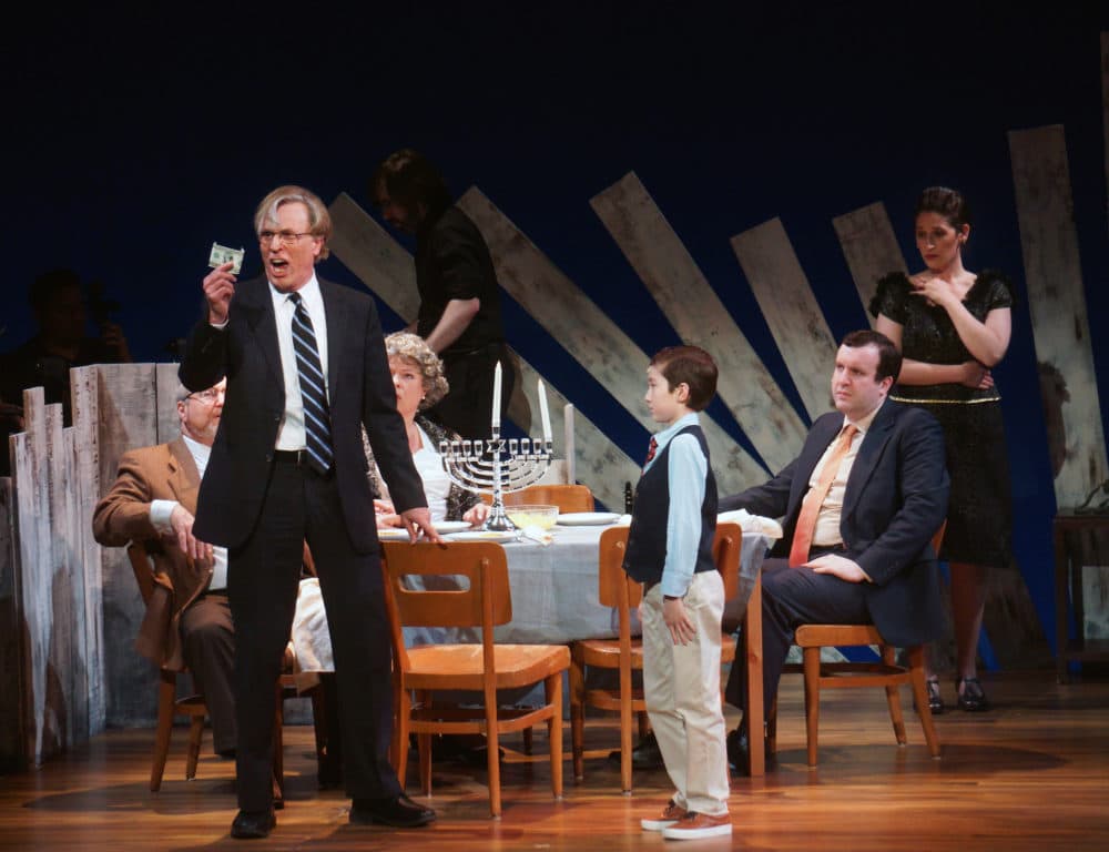 Mr. Stopnick (Phil Thompson) rails against capitalism to Noah (Ben Choi-Harris) while the rest of the family looks on bemusedly. (Courtesy Sharman Altshuler)