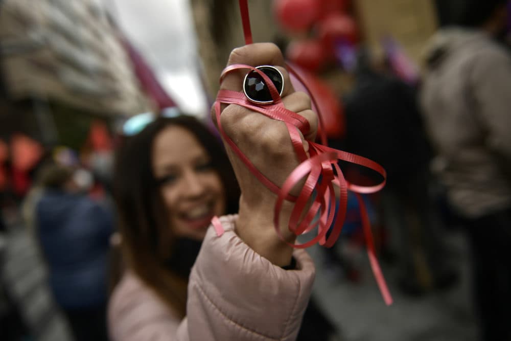 A trade union demonstrator wrapped her hand with a red ribbon during a May Day rally in Pamplona, May 1, 2018. More than 70 cities in Spain held marches calling for equal gender rights, higher salaries and pensions. (Alvaro Barrientos/AP)