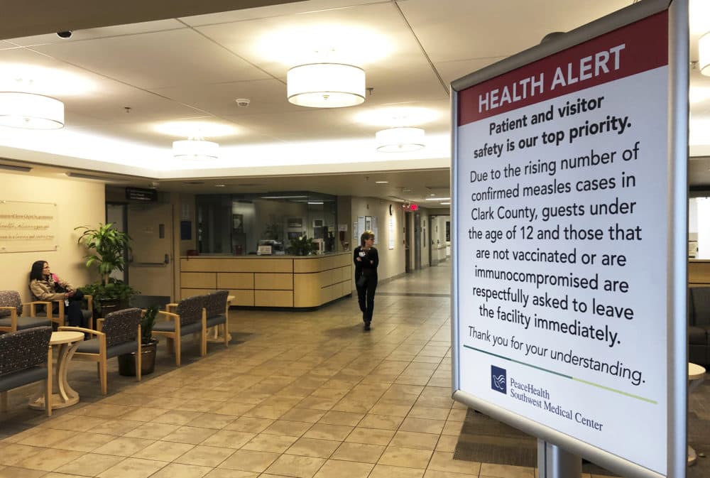 A sign prohibiting all children under 12 and unvaccinated adults stands at the entrance to PeaceHealth Southwest Medical Center in Vancouver, Wash., Jan. 25, 2019. (Gillian Flaccus/AP)