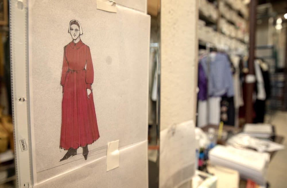 A handmaid's costume sketch on a dressing room wall at Costume Works Inc. (Robin Lubbock/WBUR)
