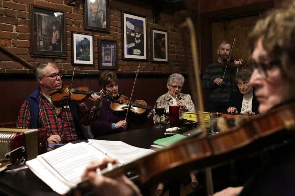 Players join an Irish music session at the Green Briar pub in Brighton on a Monday night. (Hadley Green for WBUR)