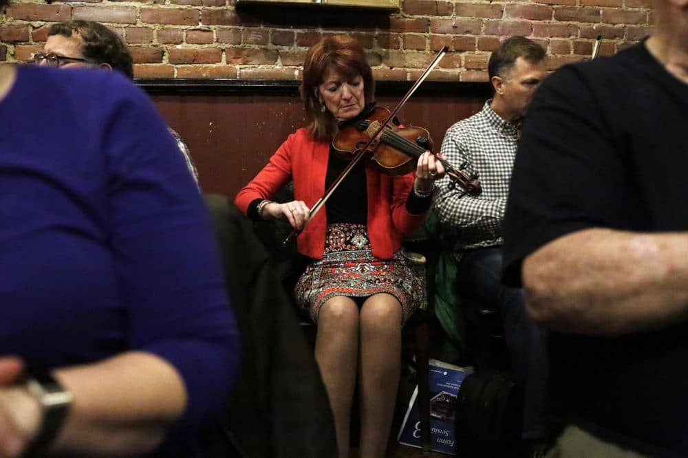 Players join an Irish music session at the Green Briar pub in Brighton on a Monday night. (Hadley Green for WBUR)