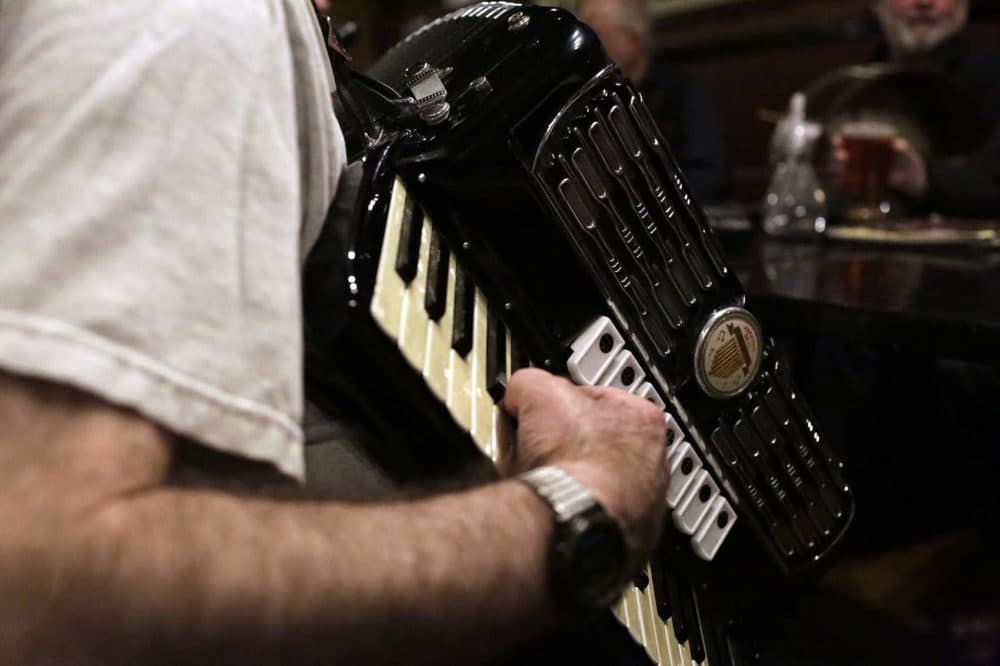 Barry Shapiro plays a piano accordion during an Irish music session at the Green Briar pub in Brighton. (Hadley Green for WBUR)