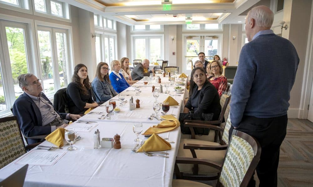 James Muller, standing, speaks about prevention of nuclear war at an inter-generational lunch at Lasell Village in Auburndale. (Robin Lubbock/WBUR)