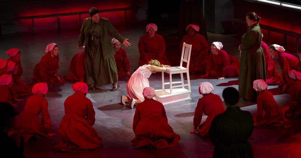 Handmaids gather round a pregnant handmaid, at a rehearsal of &quot;The Handmaid's Tale.&quot; (Robin Lubbock/WBUR)